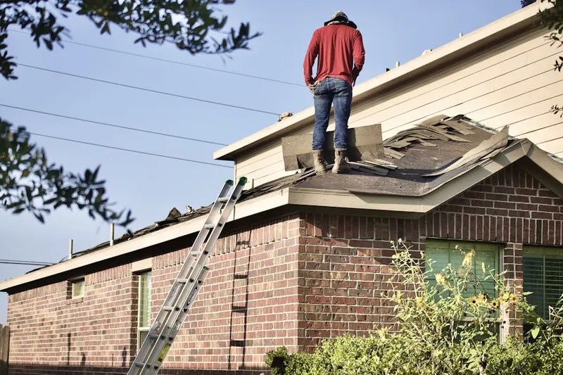 Professional roofer working on a residential roof in Brookview
